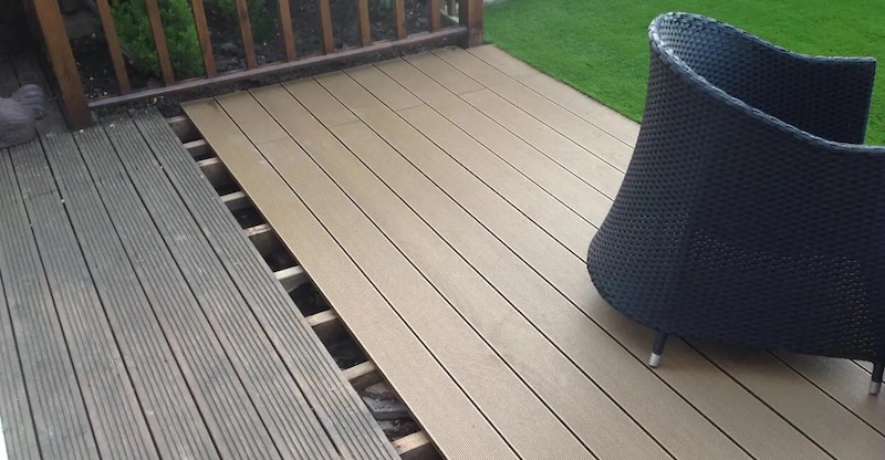 Wooden decking boards and composite decking boards installed side by side for comparison purposes