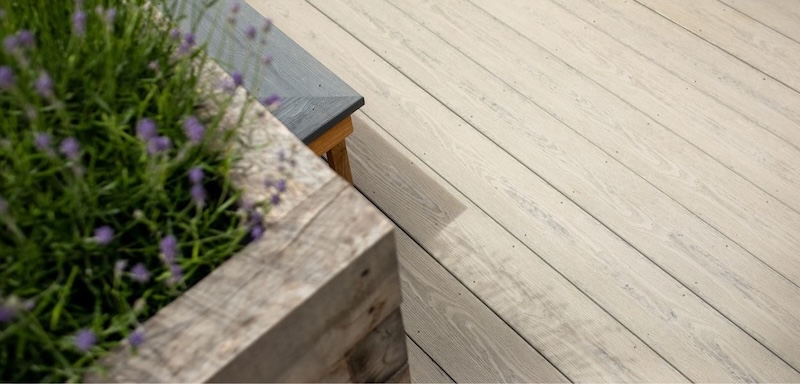 Light grey PVC decking with built-in planter and garden seating area