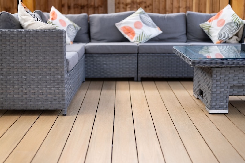 Light oak composite decking with rattan garden furniture and outdoor sofa set