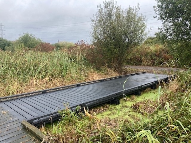 Close-up of recycled plastic decking used for a raised boardwalk over a wetland area