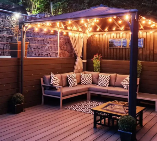 String lights installed around a decking seating area