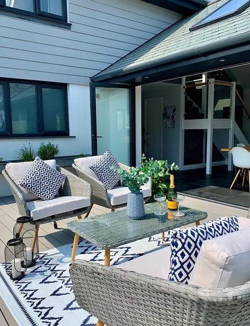 Cladco Composite Decking Boards in Ivory have been styled with a durable outdoor rug and matching accessories