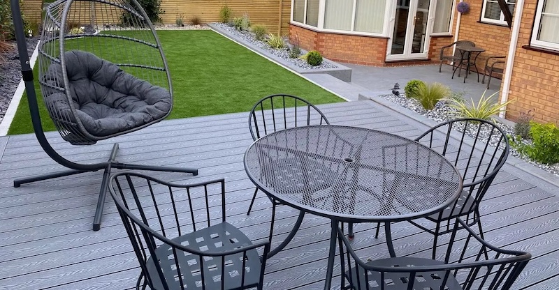 Cladco Woodgrain Stone Grey Composite Decking with metal seating and table