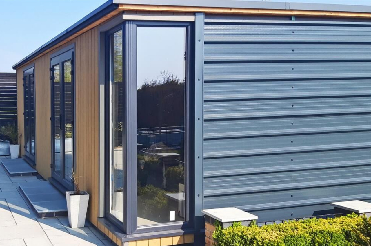 Contemporary garden building features vertical Composite Wall Cladding in Teak