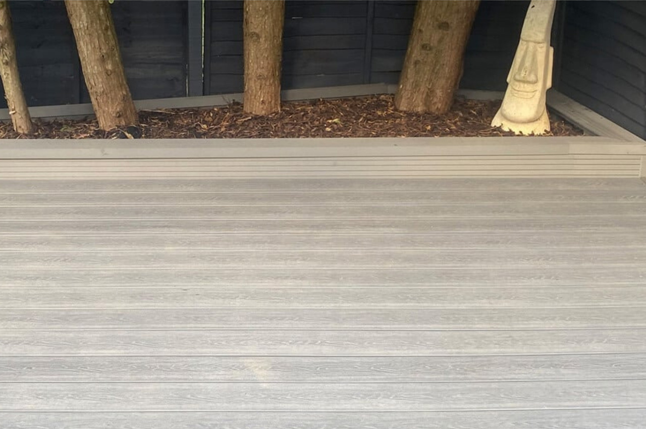 Cladco Composite Woodgrain Boards in Stone Grey make for a relaxing, raised decking in this garden