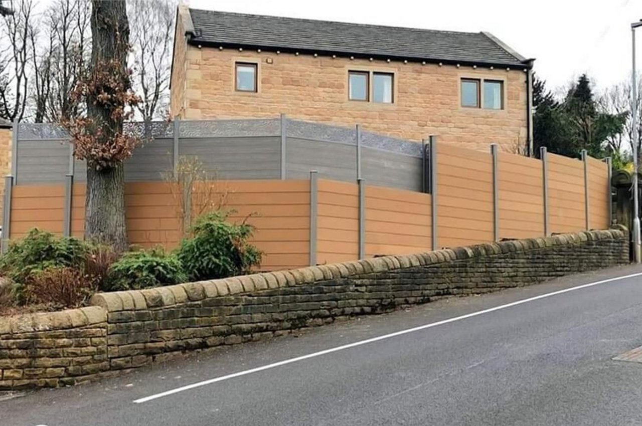 This homeowner selected Cladco Composite Fencing Panels in Teak with Stone Grey Posts