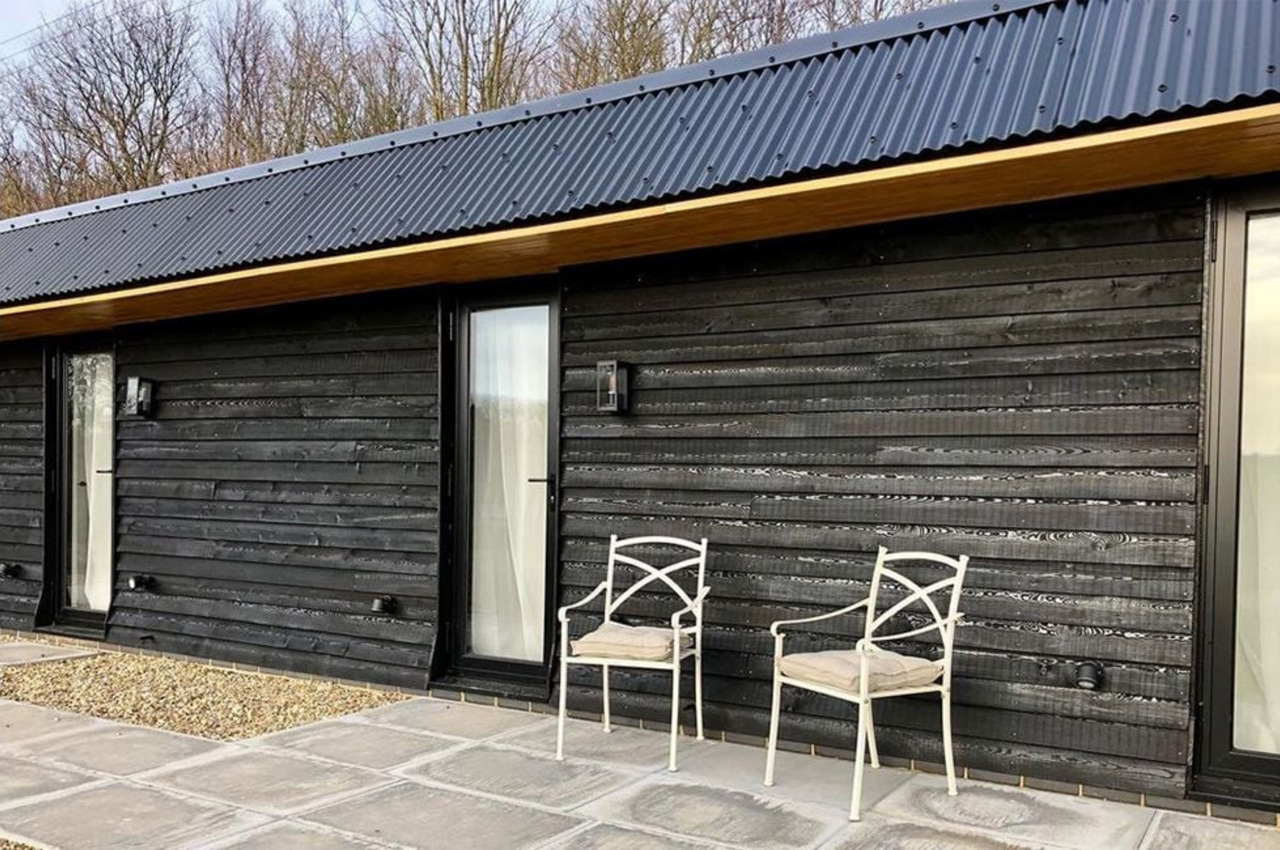 The Hopper Huts rebuild their original farm outbuildings using Cladco Corrugated Roofing Sheets in Black.