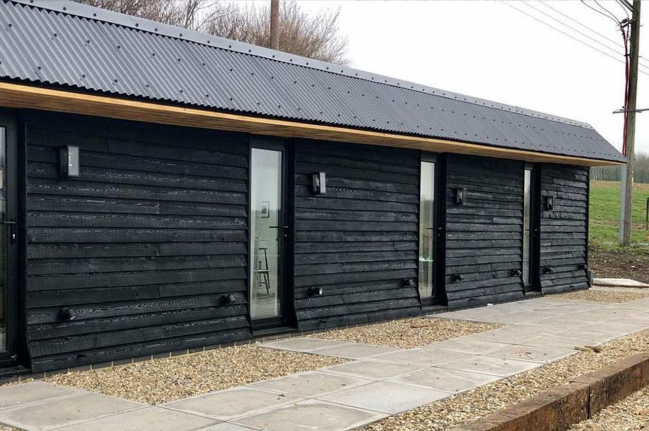 The Hopper Huts rebuild their original farm outbuildings using Cladco Corrugated Roofing Sheets in Black.