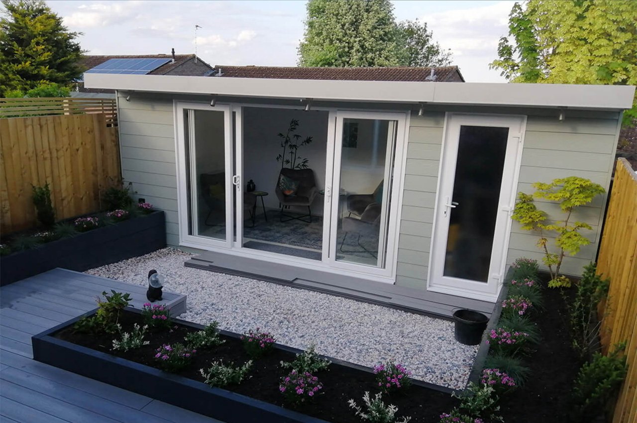 Sage Green Fibre Cement Wall Cladding Boards protect this cosy garden room