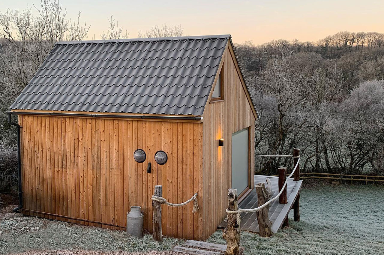 Cosy log cabin featuring Tile Form Roof Sheets in Slate Grey