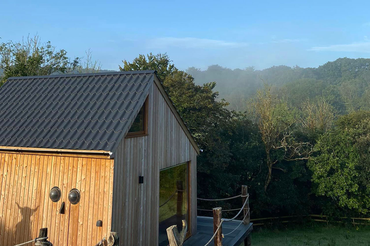 Cosy log cabin featuring Tile Form Roof Sheets in Slate Grey
