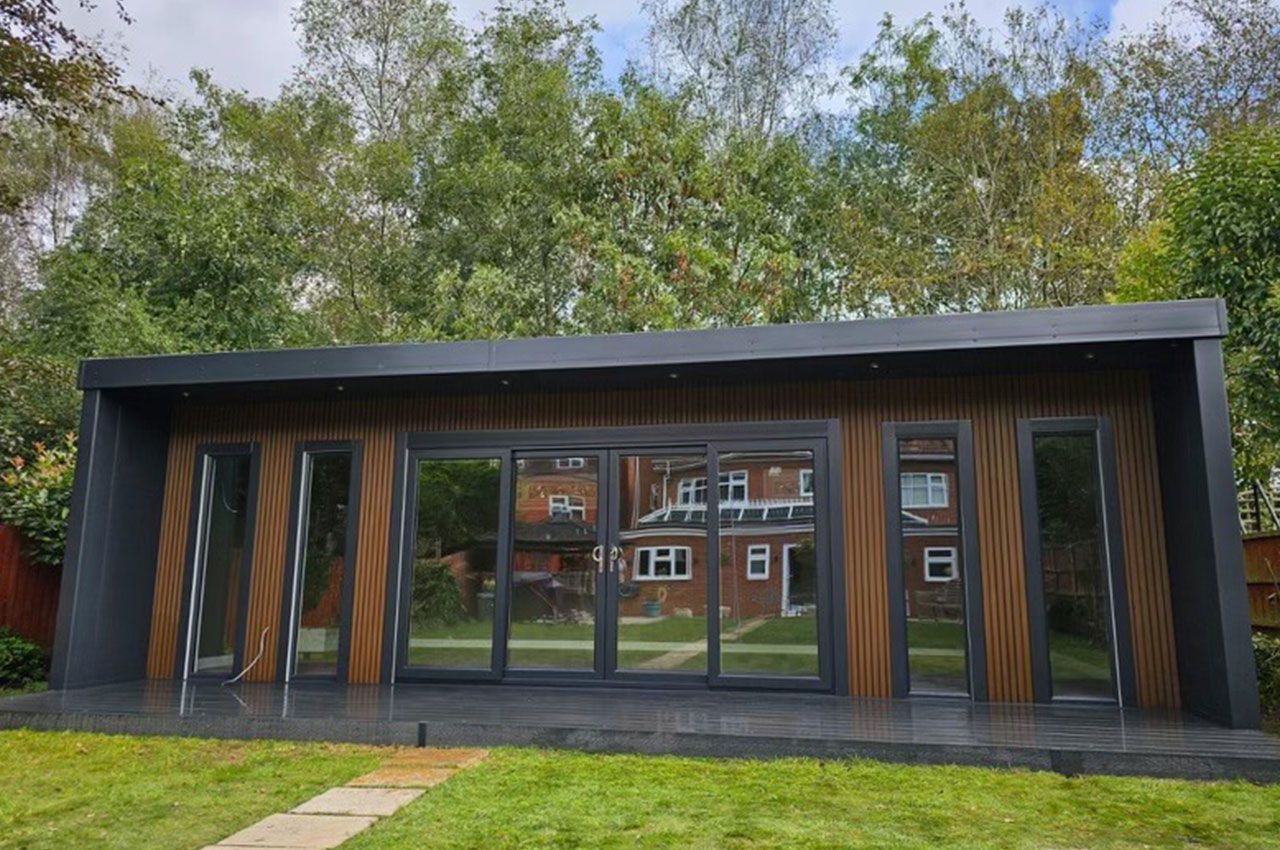 Modern summerhouse with Cladco Composite Slatted Cladding and Woodgrain Composite Decking.