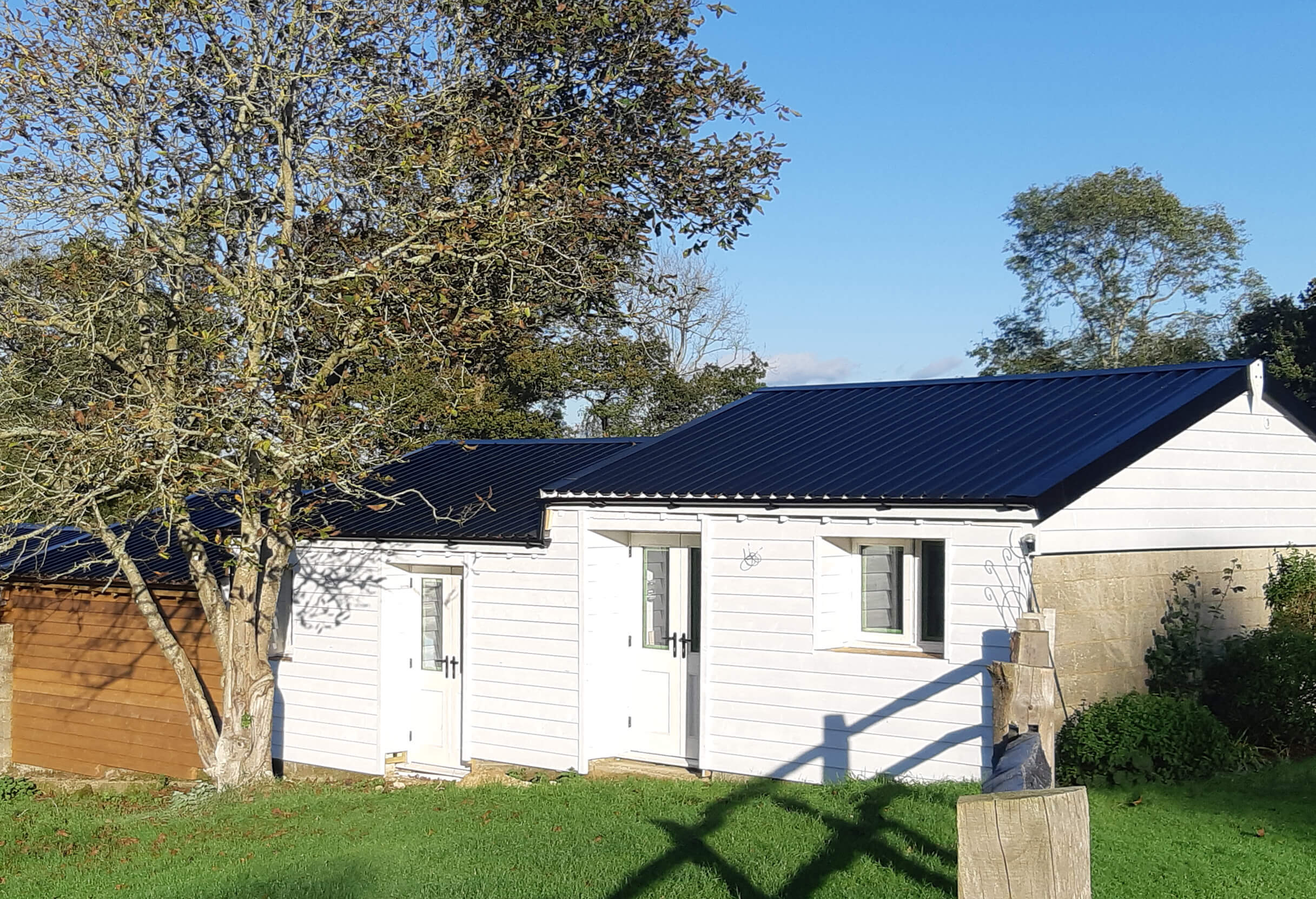 34/1000 Box Profile Sheets in Black feature on bungalows and barns in the countryside