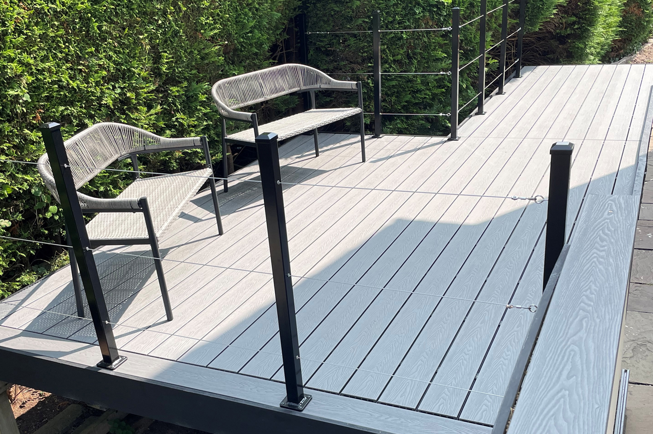 A Unique Outdoor Space With Raised Stone Grey Decking Spanning A Garden Stream