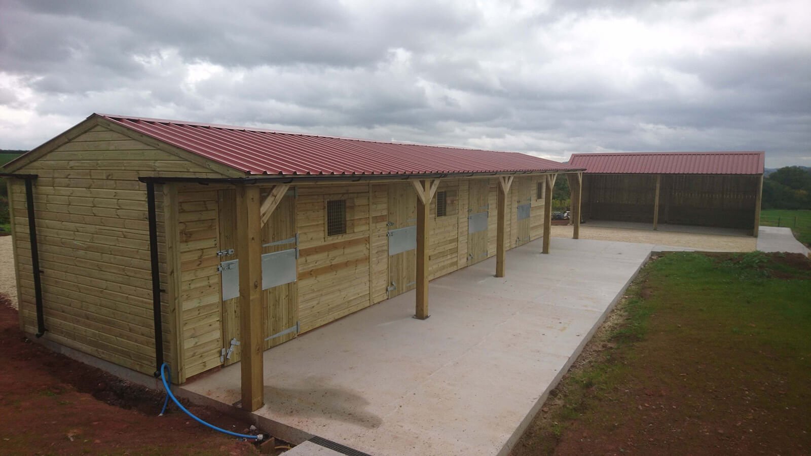 Chestnut PVC 32/1000 Box Profile sheeting on stable block