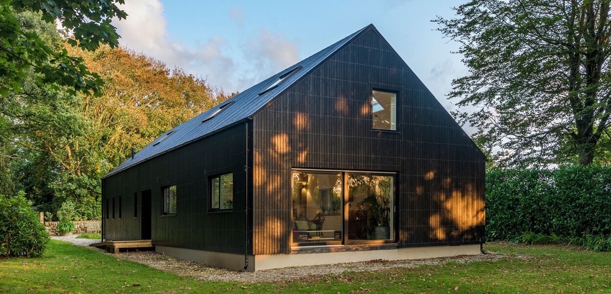 Cladco Corrugated Roofing Sheets in Black feature on this family home