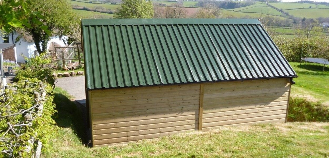 34/1000 Box Profile Roofing Sheets in Juniper Green have helped this roof blend into the surroundings