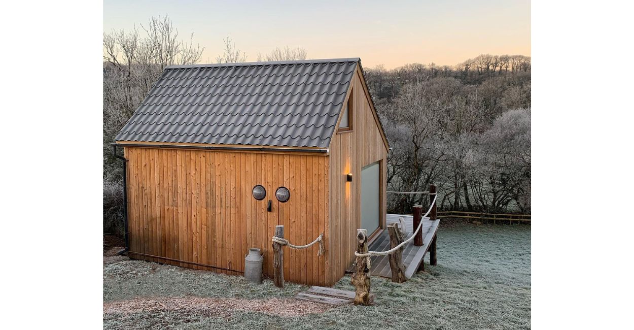 Cosy log cabin featuring Tile Form Roof Sheets in Graphite Grey