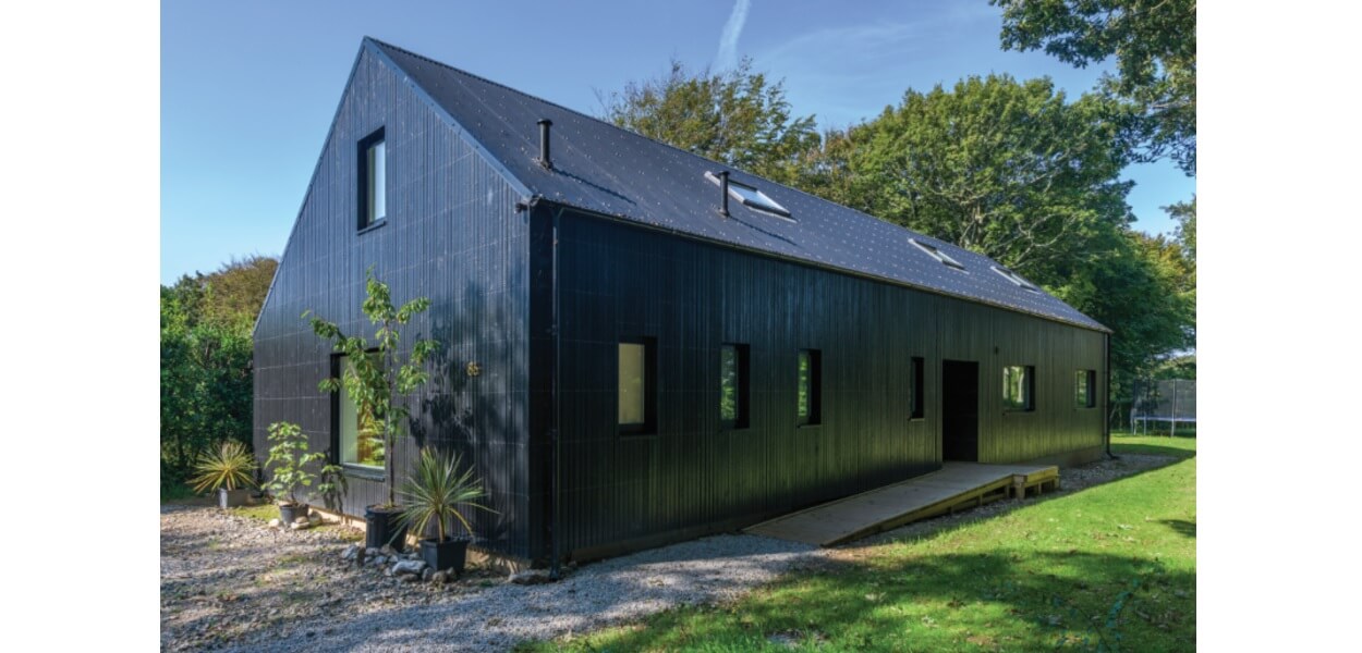 Cladco Corrugated Roofing Sheets in Black feature on this family home