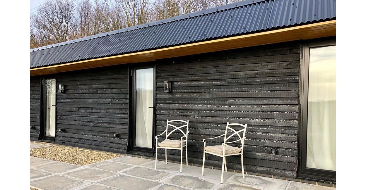The Hopper Huts rebuild their original farm outbuildings using Cladco Corrugated Roofing Sheets in Black.