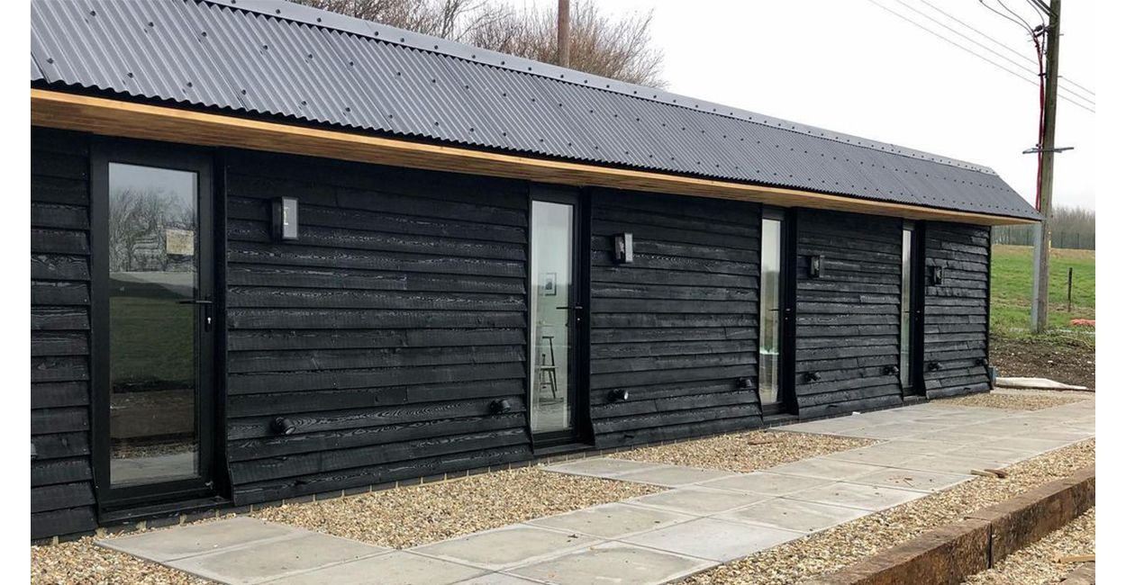 The Hopper Huts rebuild their original farm outbuildings using Cladco Corrugated Roofing Sheets in Black.