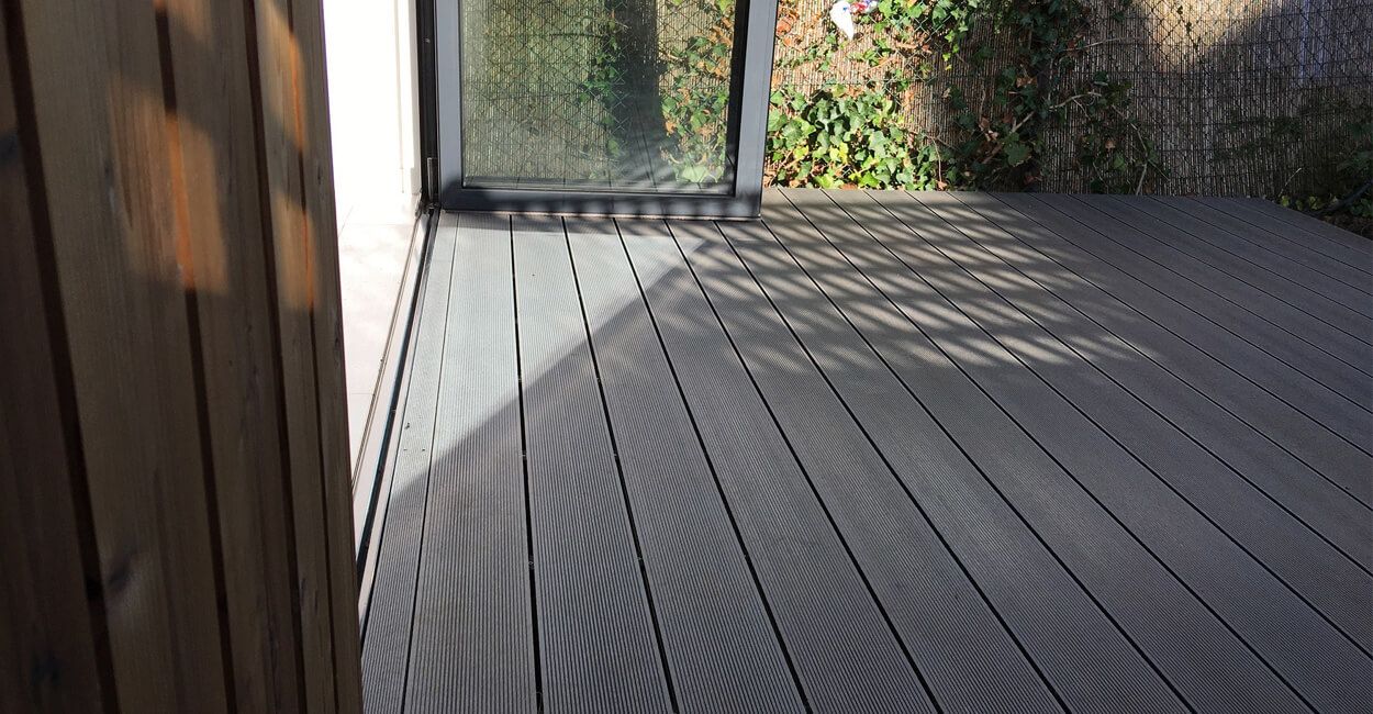 Detail of Cladco Stone Grey composite decking boards providing a sleek, low-maintenance outdoor surface.