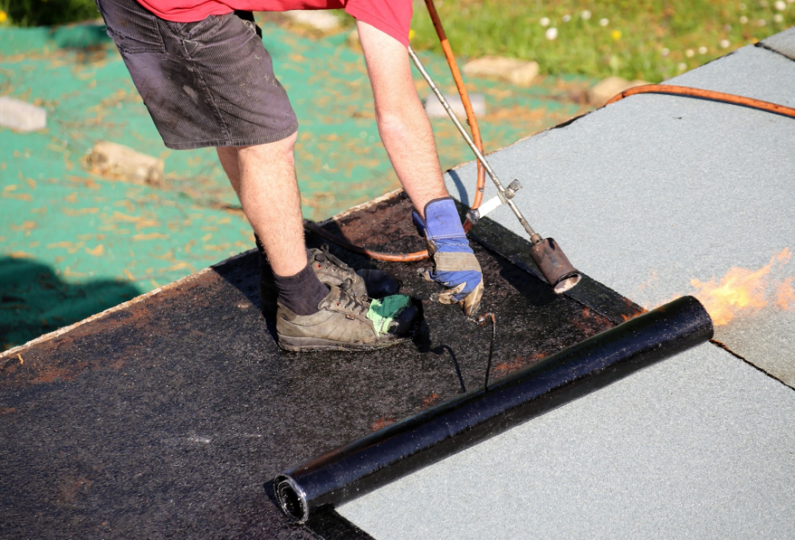 Bitumen sheeting being torched onto a roof