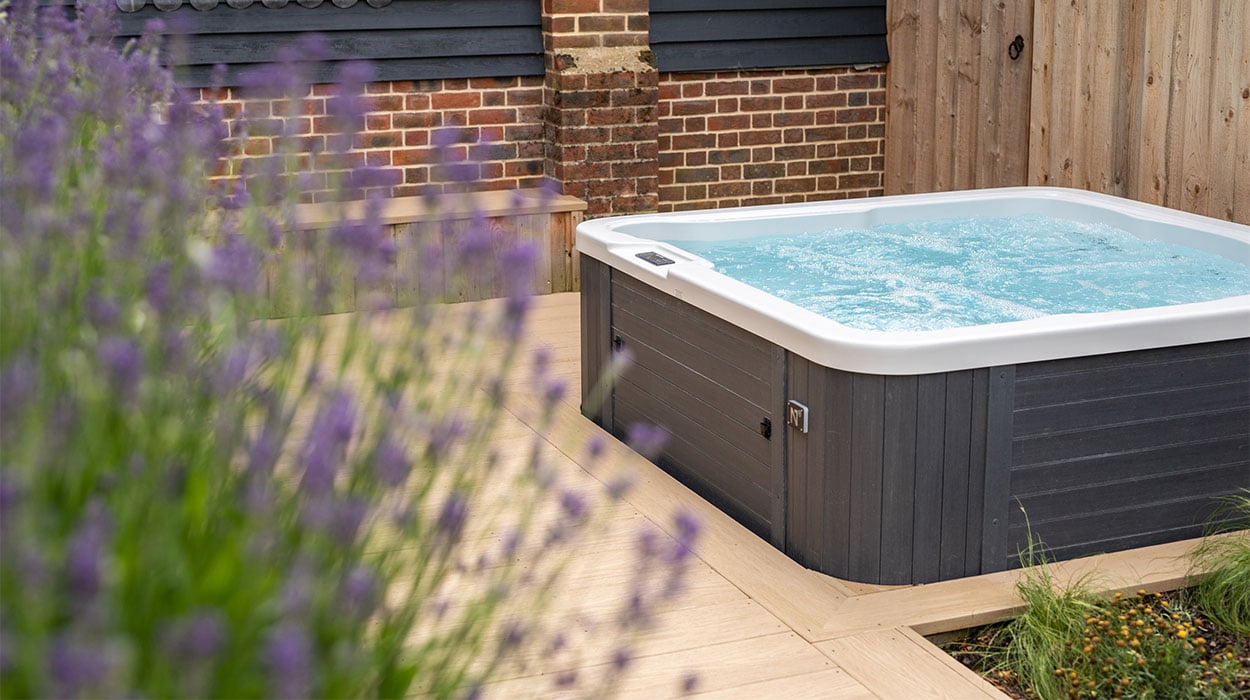 Hot tub area surrounded by Cladco Cedar Wood PVC decking at Oakwood West Holidays