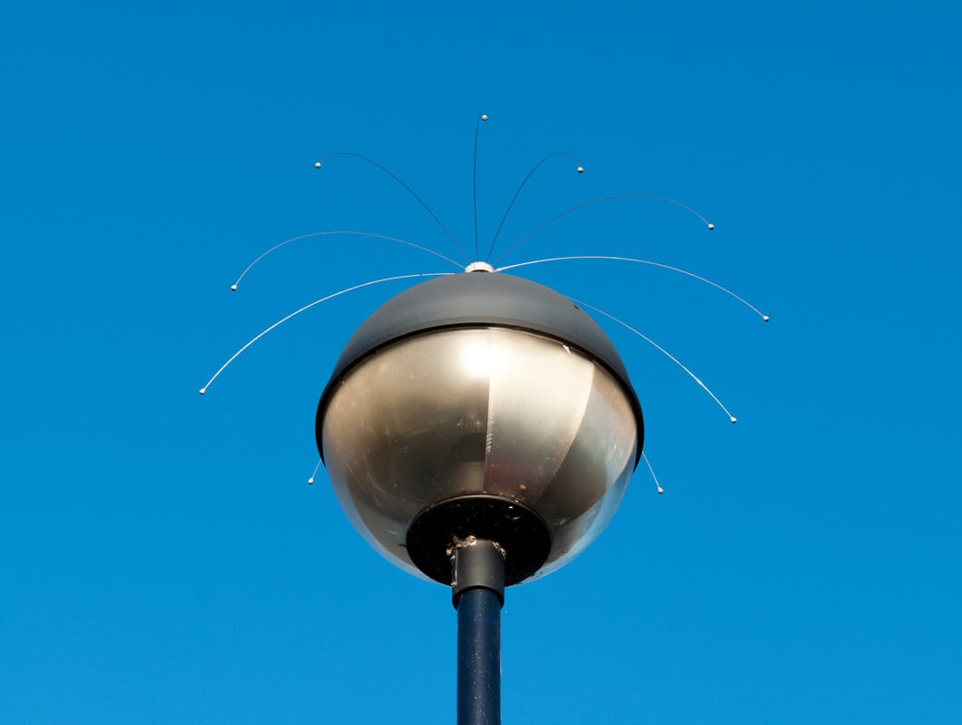 Bird deterrent device on top of street lamp