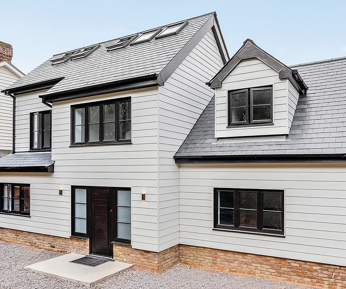 Cladco fibre cement lap cladding boards installed on this modern house in a cream white colour.