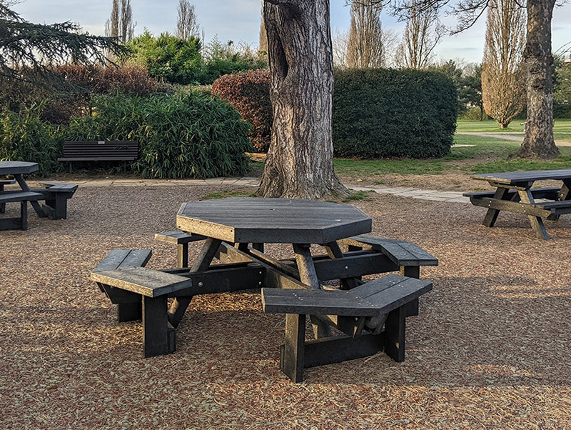 Recycled plastic furniture in a park picnic area.
