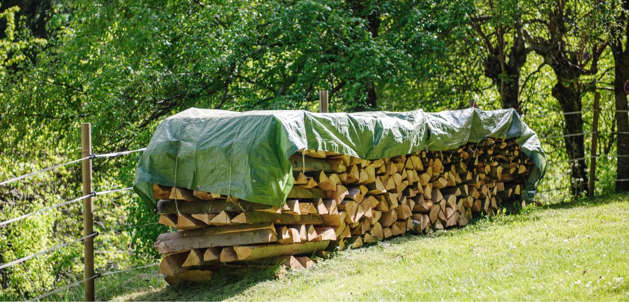 Tarpaulin covering timber logs