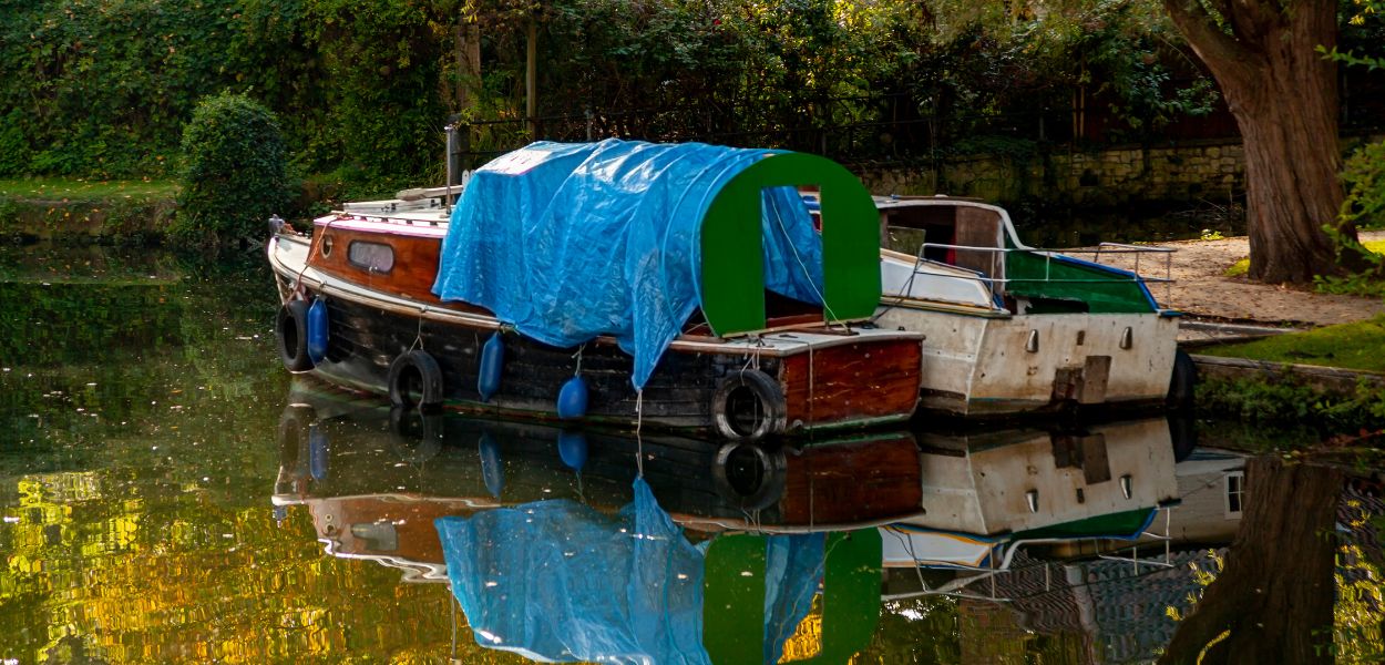 Tarpaulin on boat in water