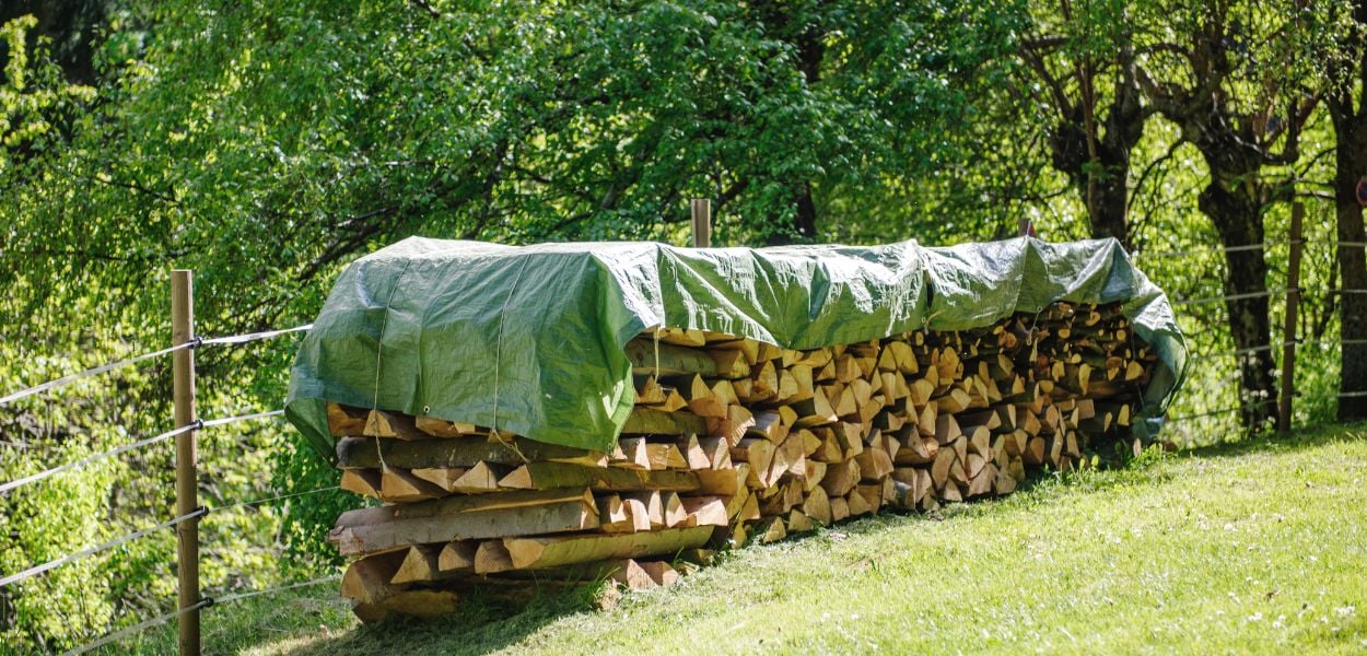 Tarpaulin used to cover log pile