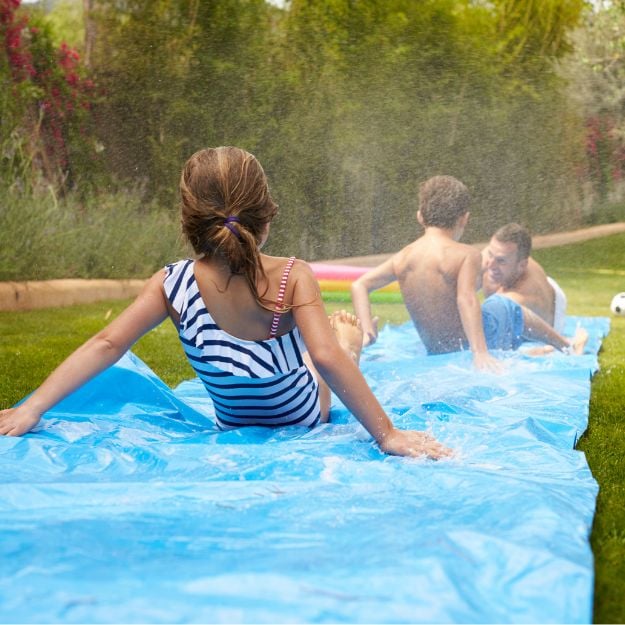 Tarpaulin slip n slide in garden