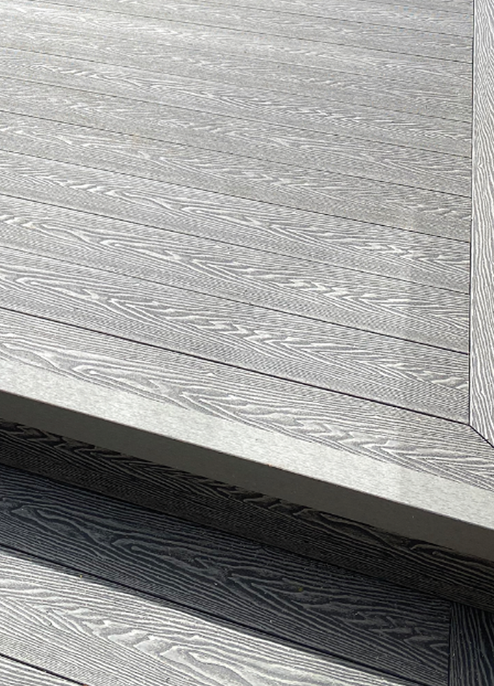 Close up of Composite Decking and step in Stone Grey.
