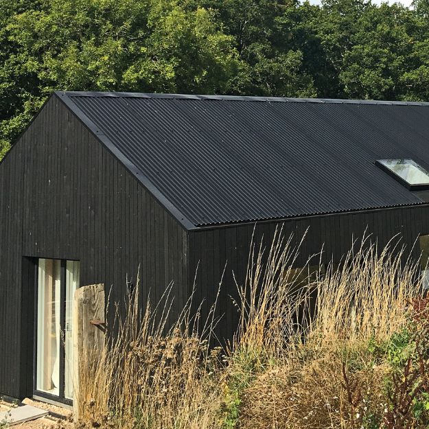 black corrugated roofing on barn style house