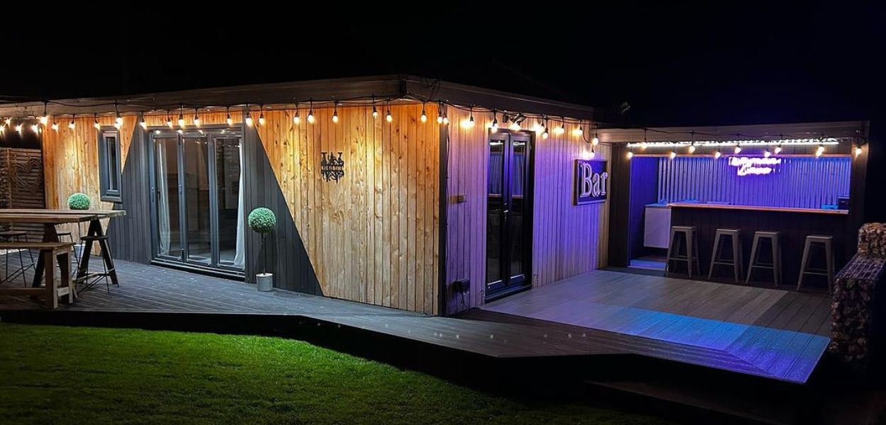 Outdoor garden bar featuring Cladco Charcoal Composite Cladding and Galvanised Corrugated Sheets by Wo-man Cave Ltd