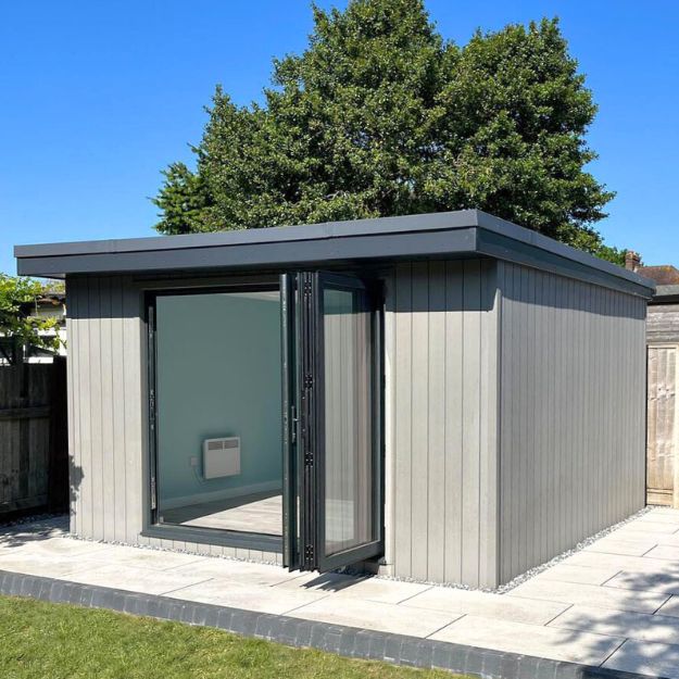 Modern garden room clad in Cladco Light Grey Composite Cladding with black bifold doors by Wo-man Cave Ltd