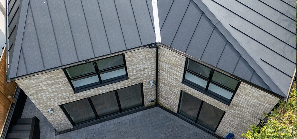 An aerial view showing the installation of Cladco standing seam roofing sheets.