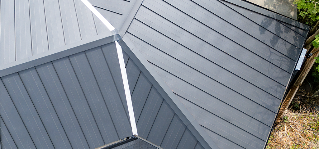 A close up of the roof clearly showing standing seam flashings.