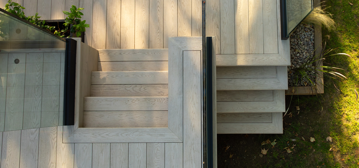 Aerial view of multi-level Millboard® Enhanced Grain limed oak decking design in contemporary Cornish garden