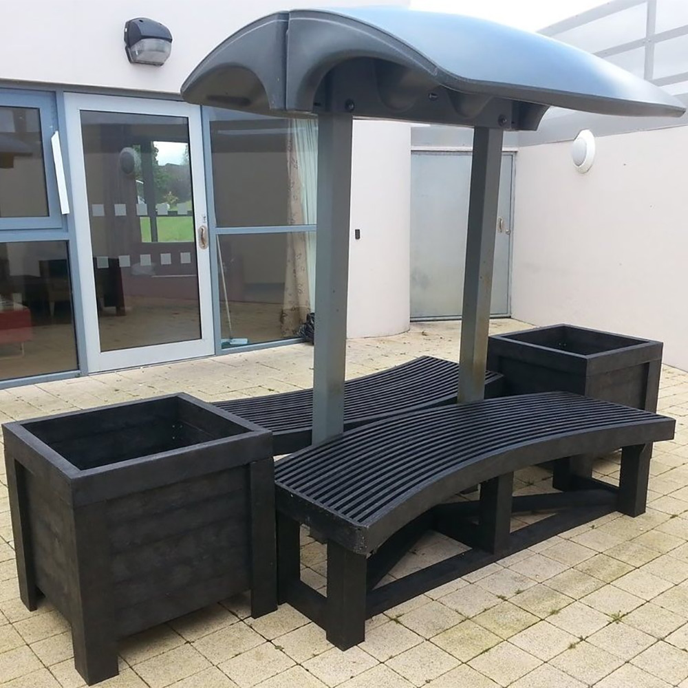 Recycled plastic benches and planters installed at a school.