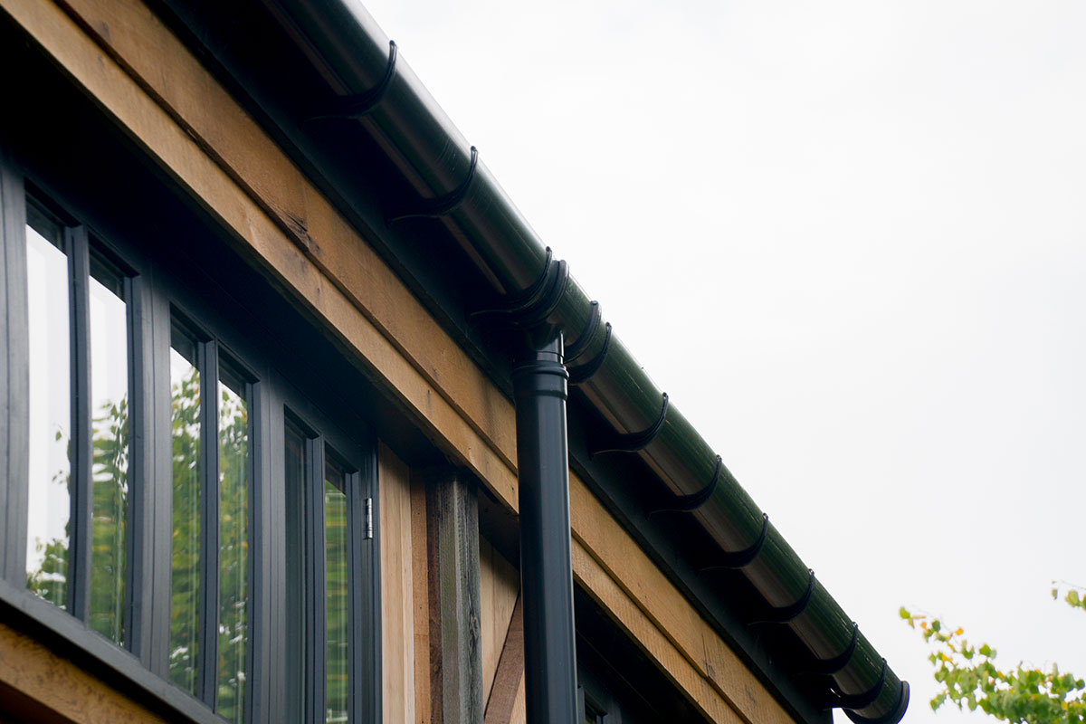 Brett Martin Deepstyle guttering system installed on a roof with downpipe.