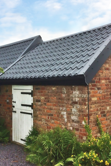 Tile Form metal roofing sheets in Graphite Grey colour form a watertight shed roof
