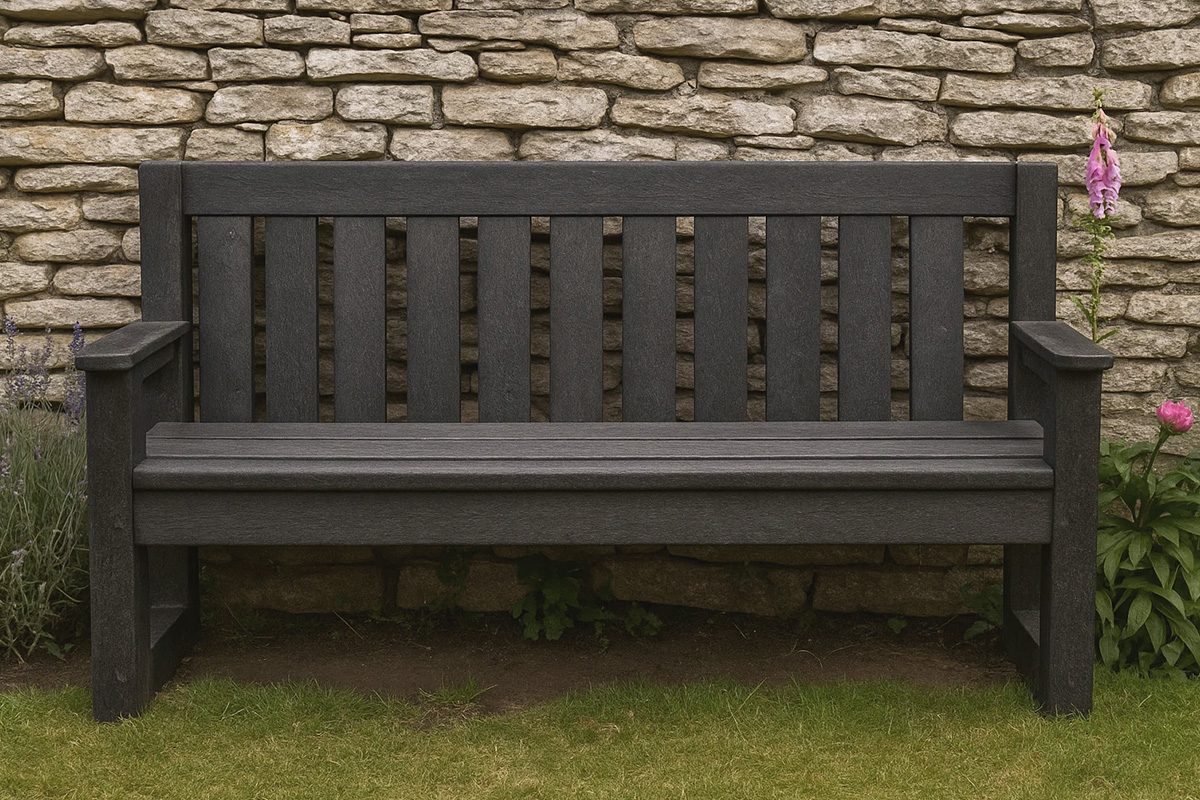Recycled plastic bench against a stone garden wall.