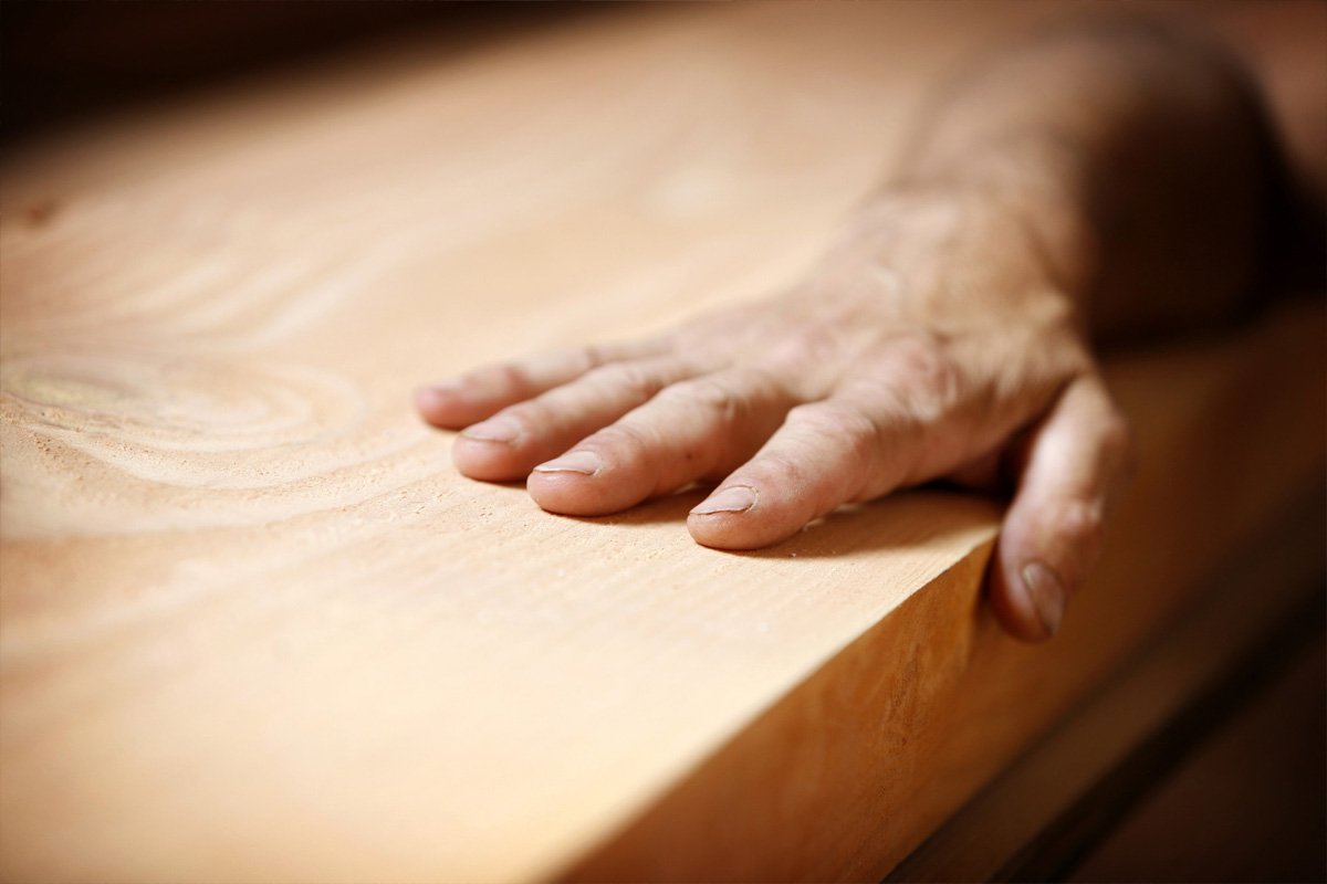 Close up shot of a timber table top with wood grain.