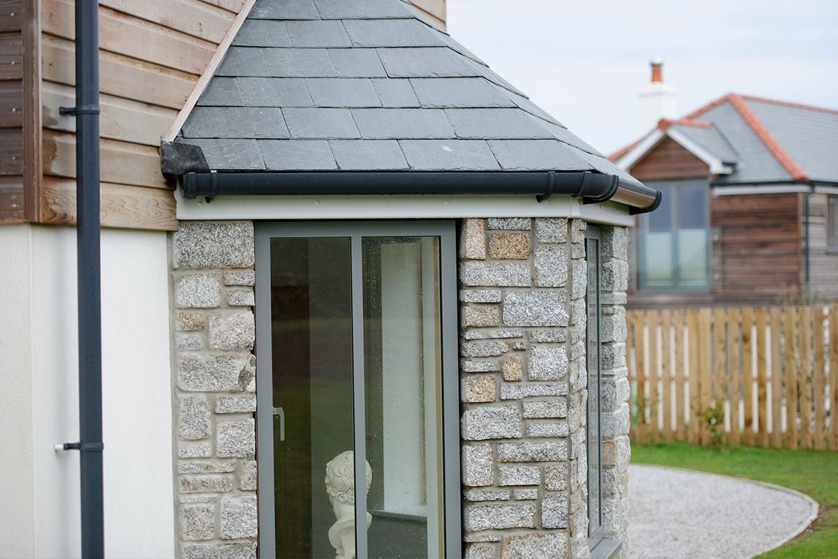 Brett Martin Deepstyle guttering system installed on a roof with downpipe.