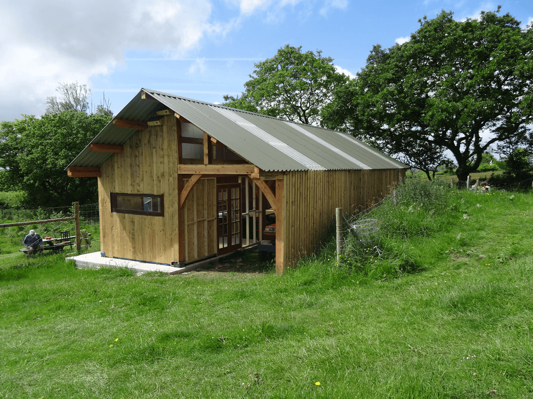 Cladco 34/1000 profile metal roofing sheets in Olive Green on a barn.