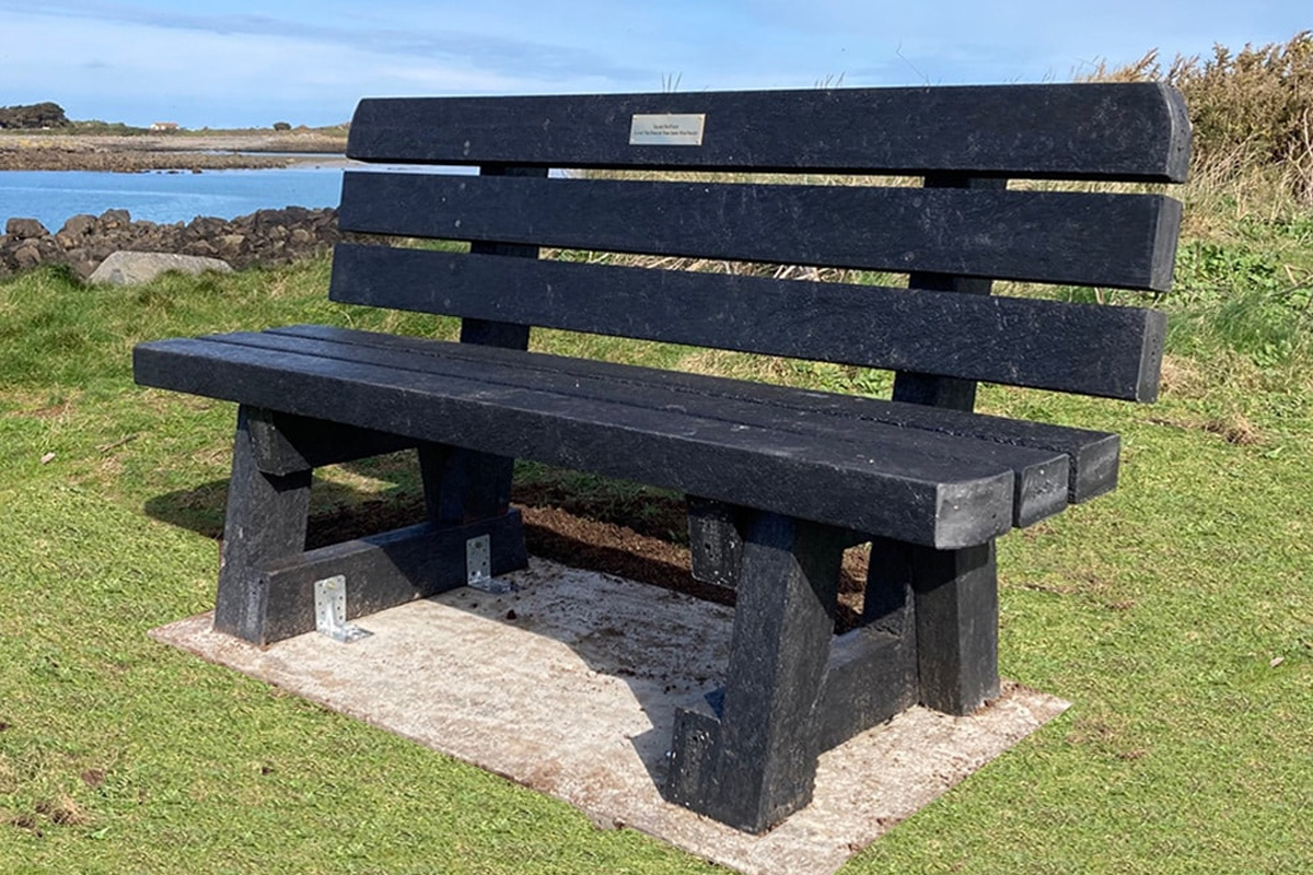 Recycled plastic memorial bench installed in a coastal park, highlighting the long-lasting and sustainable choice for public spaces.